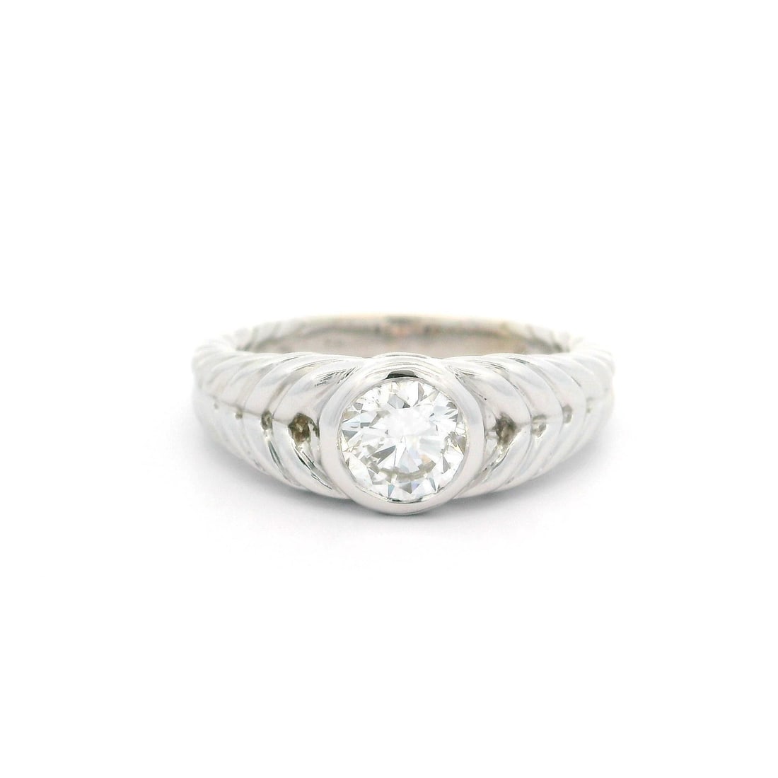 18k White Gold GIA Certified .75ct Diamond Solitaire Cable Braided Ring: 18k White Gold GIA Certified .75ct Diamond Solitaire Cable Braided Ring This exquisite ring showcases a stunning 0.75 carat natural diamond, expertly set in a stylish bezel design. Crafted from solid
