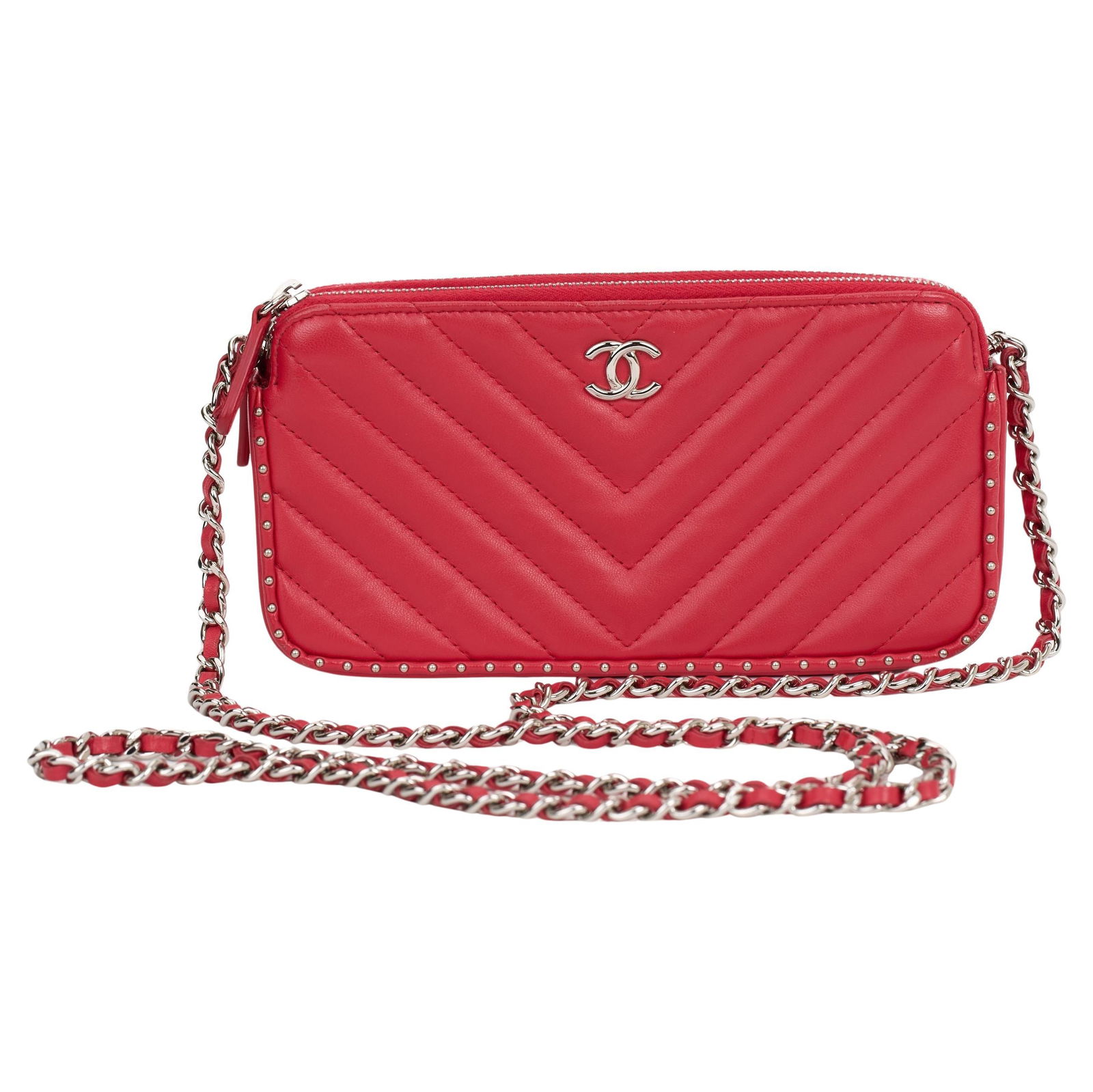 Chanel Red Lambskin Chevron Quilted Crossbody with Studs: Chanel Red Lambskin Chevron Quilted Crossbody with Studs Elevate your style with this Chanel Red Chevron Quilted Stud Crossbody. Crafted from luxurious lambskin, this chic bag features a striking chev