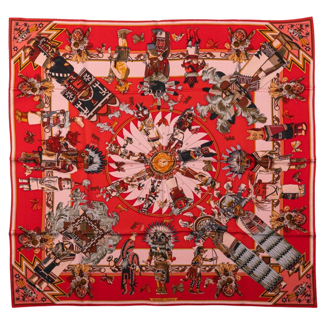 Hermes Kachinas Red Coral Silk Scarf by Kermit Oliver 35 in: Hermes Kachinas Red Coral Silk Scarf by Kermit Oliver 35 in Elevate your accessory collection with this exquisite Hermes Kachinas Silk Scarf in a vibrant red coral hue, designed by the renowned Kermit