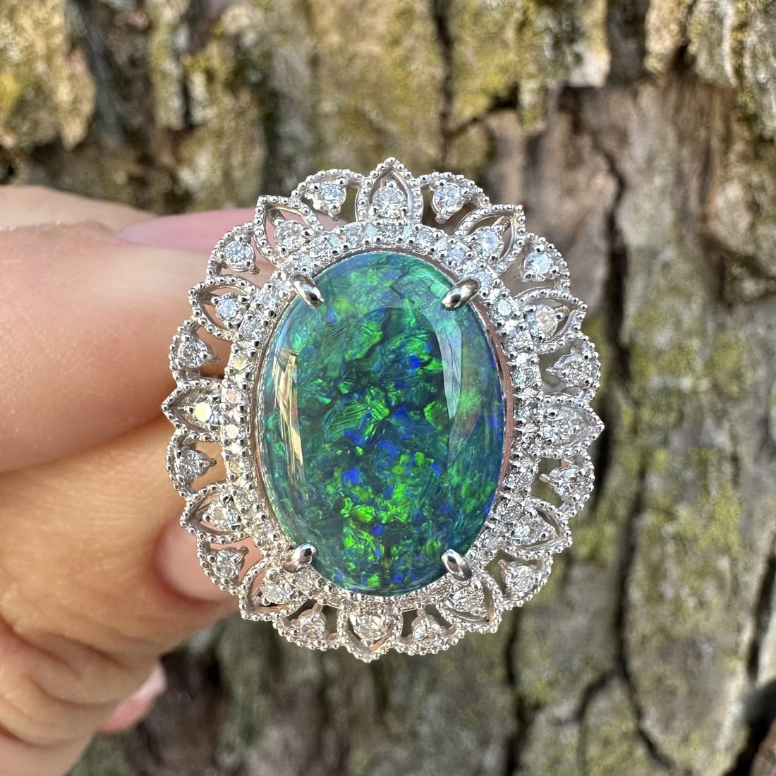 Platinum 5.50ct GIA Australian Black Opal Diamond Cocktail Ring: Platinum 5.50ct GIA Australian Black Opal Diamond Cocktail Ring This exquisite cocktail ring features a stunning 5.00ct natural Australian oval black opal, beautifully showcased with a play of colors