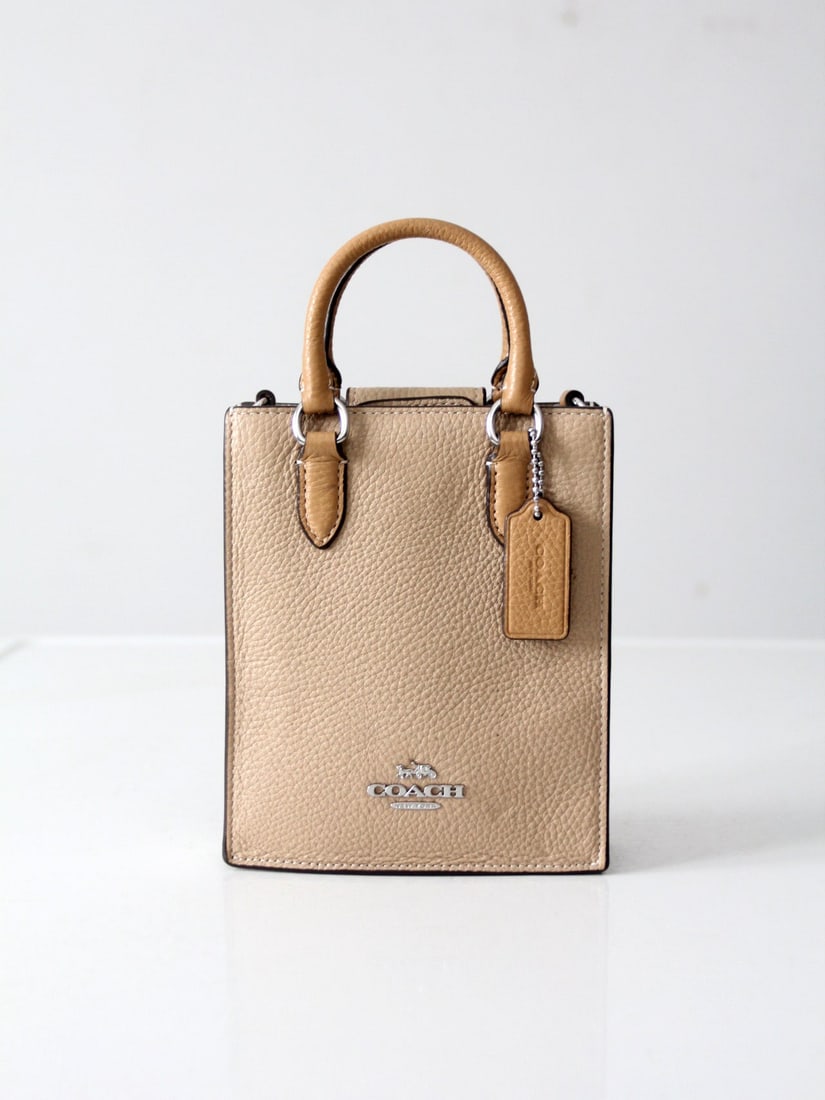 Coach Pebble Leather Mini Tote Bag Silver Hardware Compact Design: Coach Pebble Leather Mini Tote Bag Silver Hardware Compact Design This stylish Coach Mini Tote Bag is expertly crafted from rich pebbled leather and features polished silver-tone hardware. With a stru