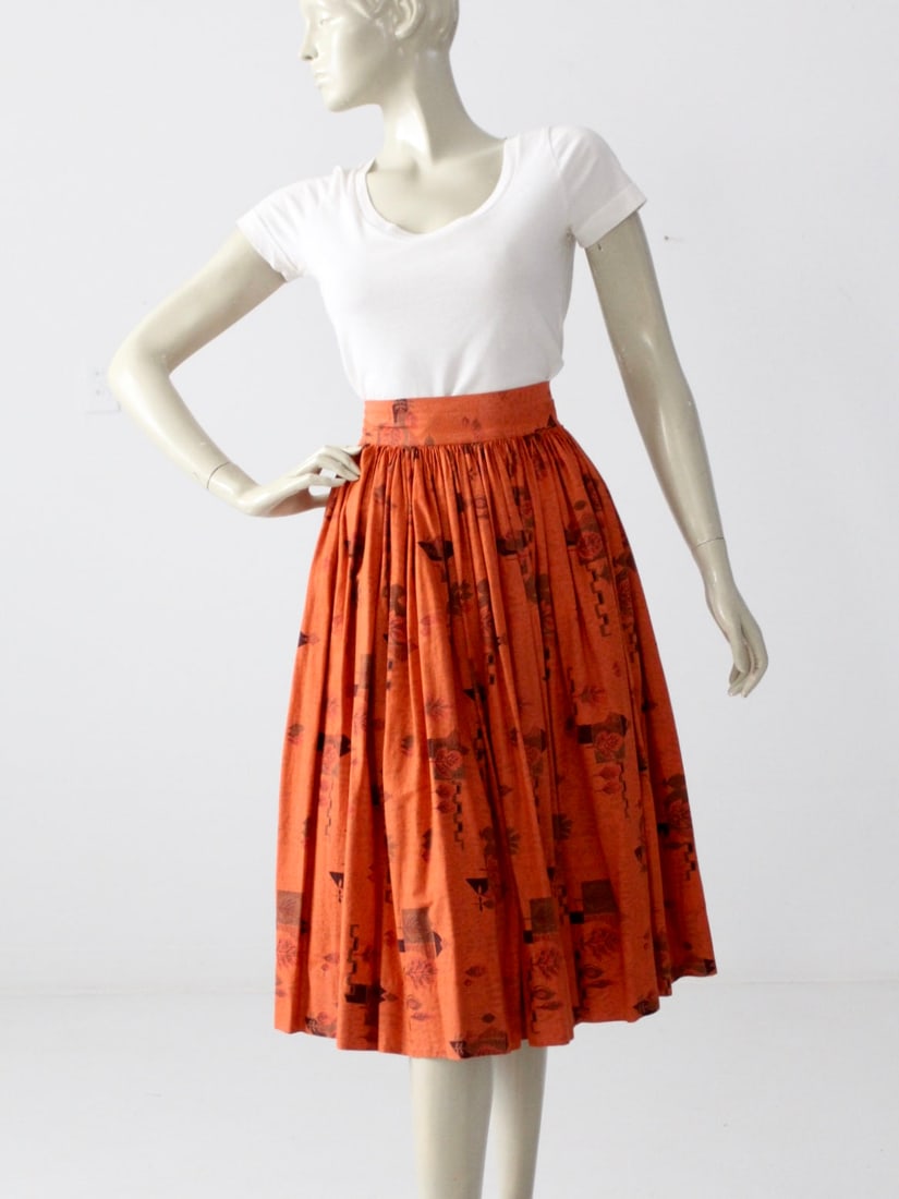 1950s Vintage Southwestern Circle Skirt Golden Orange Cotton: 1950s Vintage Southwestern Circle Skirt Golden Orange Cotton This vintage 1950s Southwestern circle skirt features a vibrant golden orange cotton fabric adorned with a southwestern print in shades of