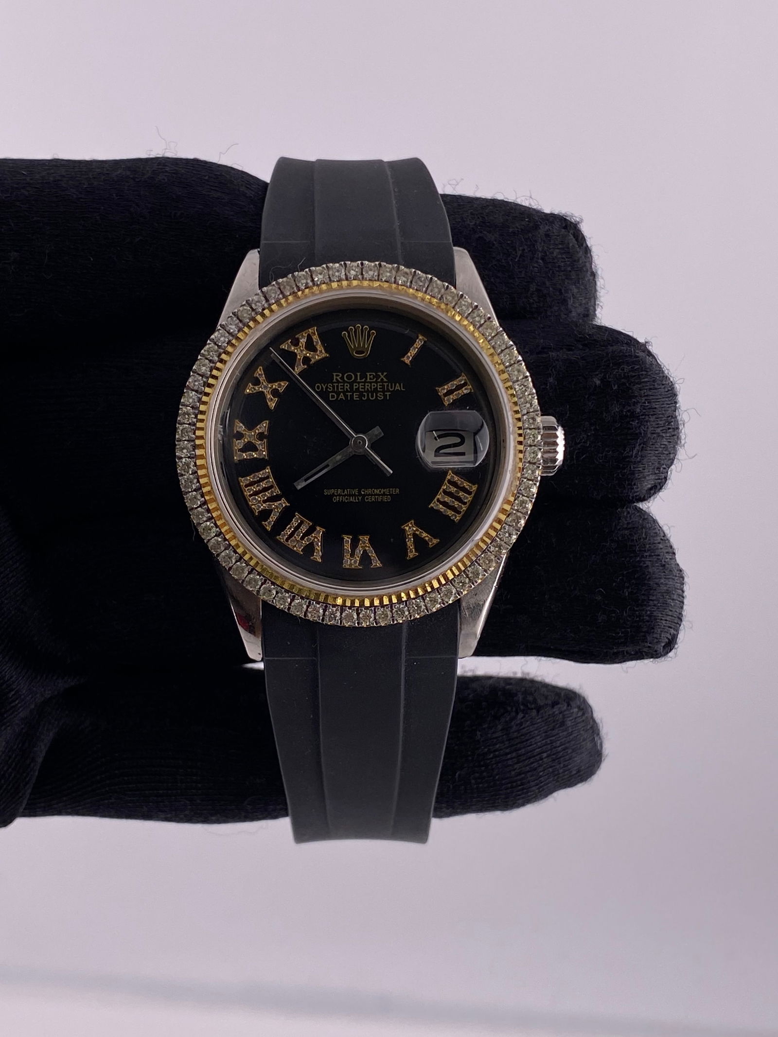 Datejust Ref 1601 Mens Watch Aftermarket Black Roman Dial Diamond Bezel Rubber Strap: Datejust Ref 1601 Mens Watch Aftermarket Black Roman Dial Diamond Bezel Rubber Strap This men's Rolex Datejust watch features an aftermarket black Roman numeral dial, a diamond bezel, and an aftermark
