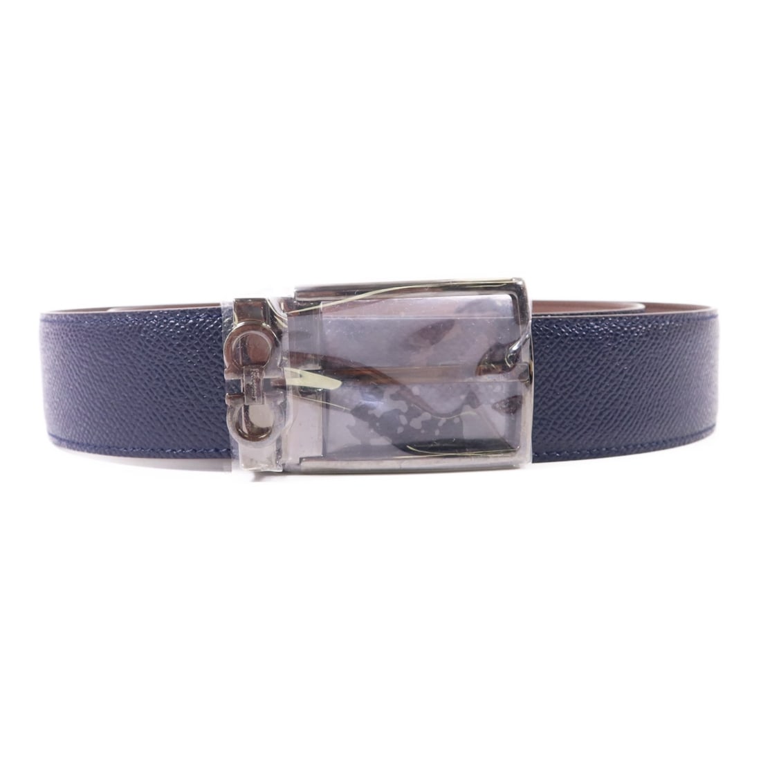Salvatore Ferragamo Navy Blue Calfskin Leather Belt: Salvatore Ferragamo Navy Blue Calfskin Leather Belt This exquisite Salvatore Ferragamo belt is crafted from premium calfskin leather, showcasing a sophisticated navy blue color. Designed for men, it f