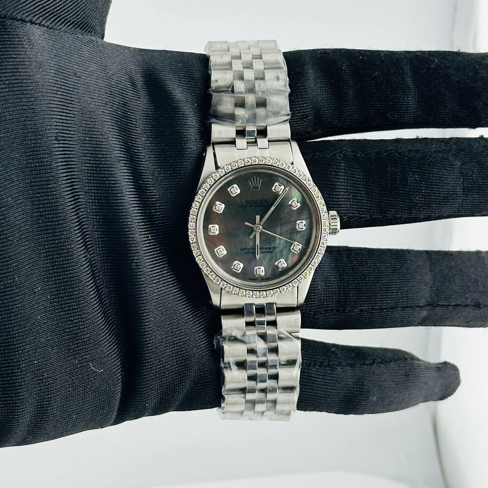 Oyster Perpetual Ref 6426 Watch with Aftermarket Black MOP Diamond Dial: Oyster Perpetual Ref 6426 Watch with Aftermarket Black MOP Diamond Dial This Rolex Oyster Perpetual watch features an aftermarket black mother-of-pearl dial with diamond hour markers, complemented by