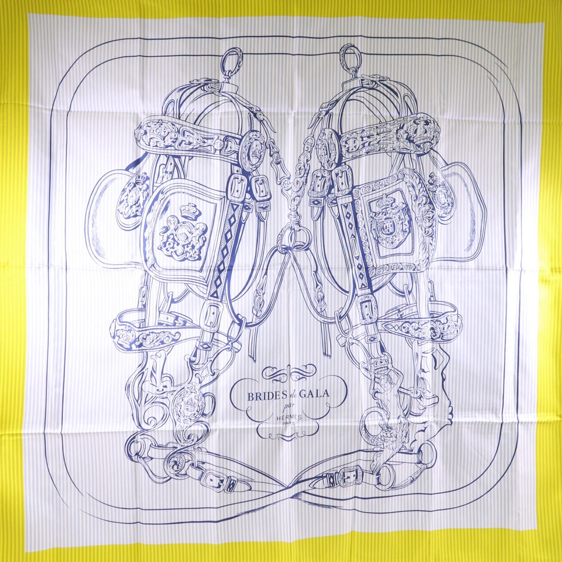 HERMES Silk Scarf in Yellow and Blue from France: HERMES Silk Scarf in Yellow and Blue from France This elegant HERMES scarf is crafted from luxurious silk, showcasing a vibrant yellow color that is sure to brighten any outfit. The scarf is designed