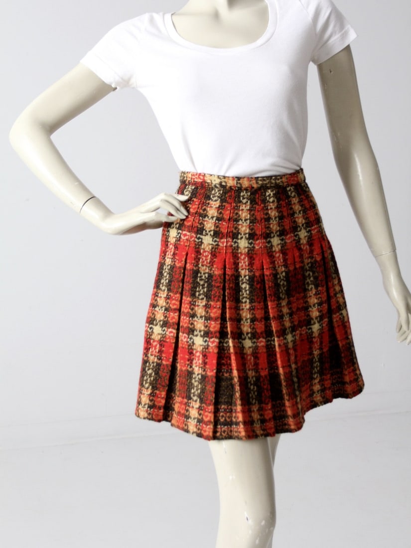1960s Vintage Plaid Mini Skirt Red Black Yellow Box Pleated: 1960s Vintage Plaid Mini Skirt Red Black Yellow Box Pleated Step back in time with this charming 1960s vintage plaid mini skirt. This delightful skirt features a classic red, black, and yellow plaid d