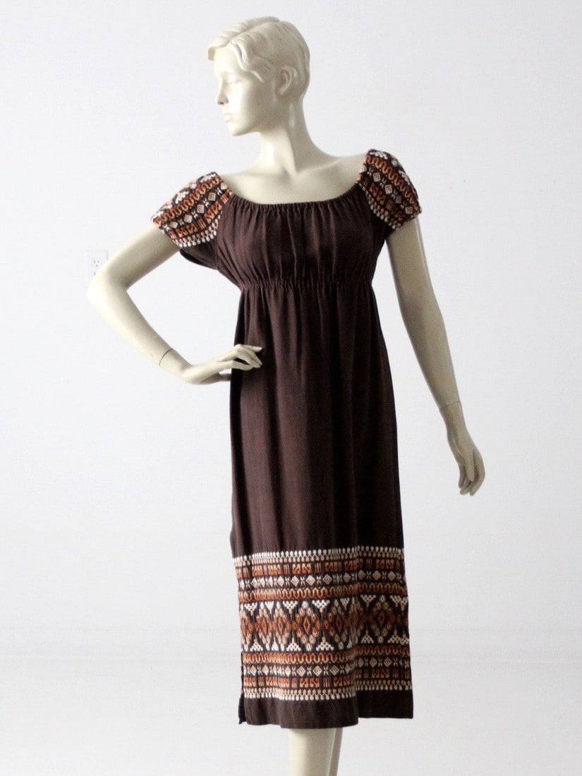 Vintage 70s Chocolate Brown Embroidered Peasant Dress: Vintage 70s Chocolate Brown Embroidered Peasant Dress Discover the charm of the past with this Vintage 70s Embroidered Peasant Dress. Crafted from heavy chocolate brown cotton, this dress showcases a