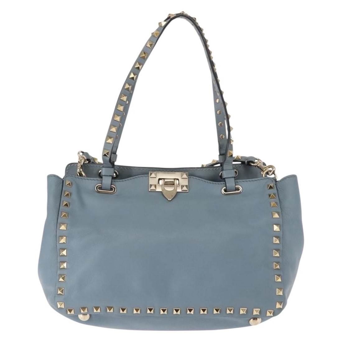 Rockstud Tote Bag by Valentino Garavani in Blue: Rockstud Tote Bag by Valentino Garavani in Blue This pre-owned Valentino Garavani Rockstud Tote in blue is designed for women and features both handles and a shoulder strap. The bag shows signs of pre