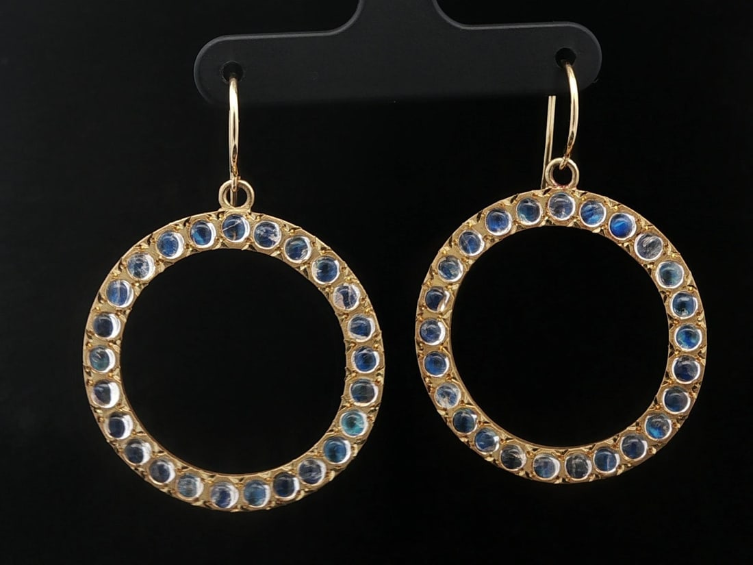 Dangle Earrings in 18k Yellow Gold with Natural Blue Moonstone Cabochons: Dangle Earrings in 18k Yellow Gold with Natural Blue Moonstone Cabochons These vintage dangle drop earrings are crafted from solid 18k yellow gold and feature an open circle design adorned with 51 nat