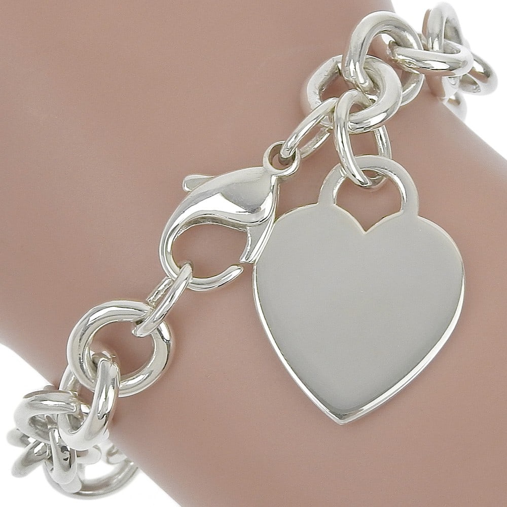 Silver Heart Tag Bracelet by Tiffany & Co.: Silver Heart Tag Bracelet by Tiffany & Co. This Tiffany & Co. Return To Tiffany Heart Tag Bracelet features a polished silver finish with fine scratches and no odor. Designed for female wearers, it is