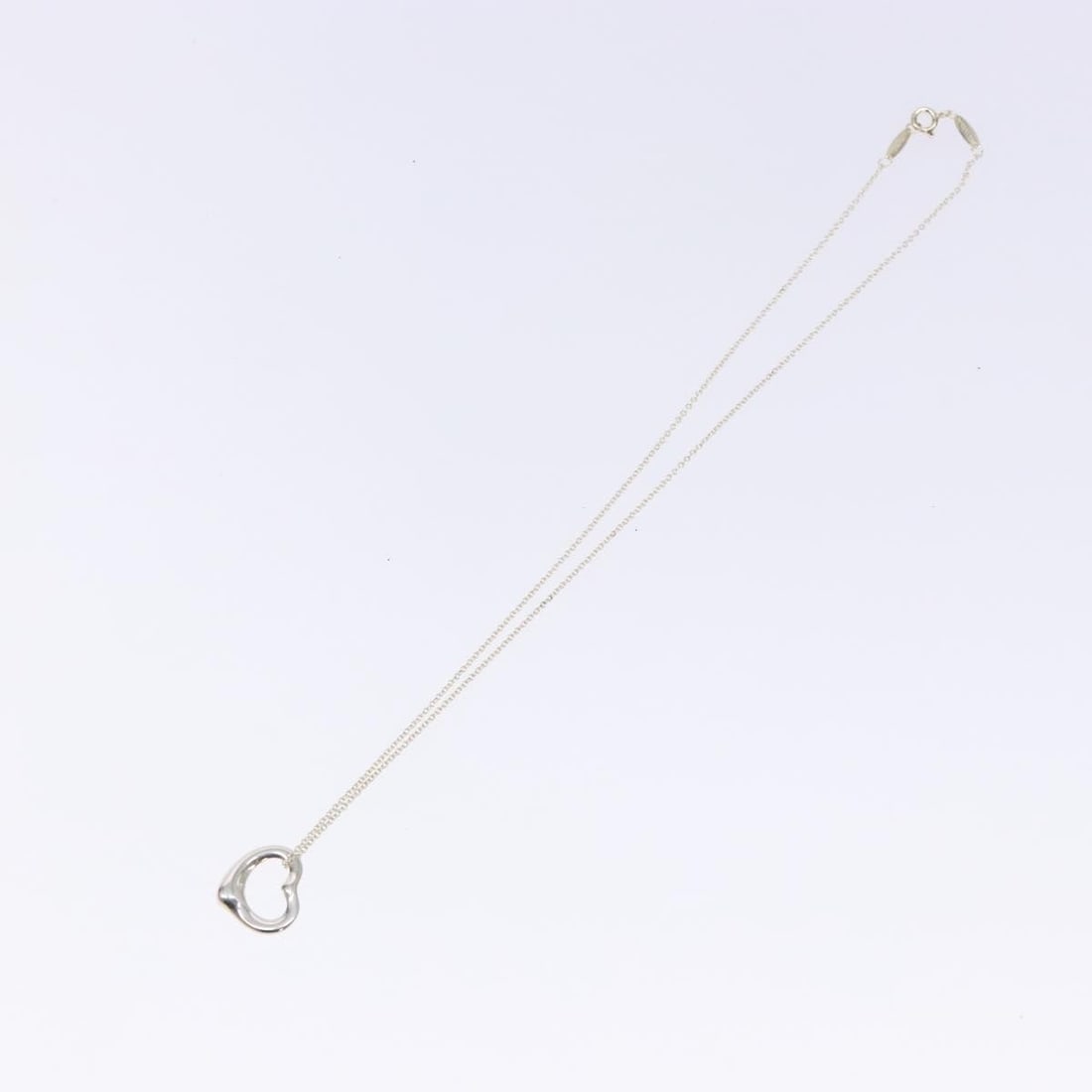 Elsa Peretti Silver Open Heart Pendant Necklace by Tiffany & Co.: Elsa Peretti Silver Open Heart Pendant Necklace by Tiffany & Co. This Tiffany & Co. Elsa Peretti Open Heart Pendant Necklace for women features a classic open heart design crafted in silver. The neckl