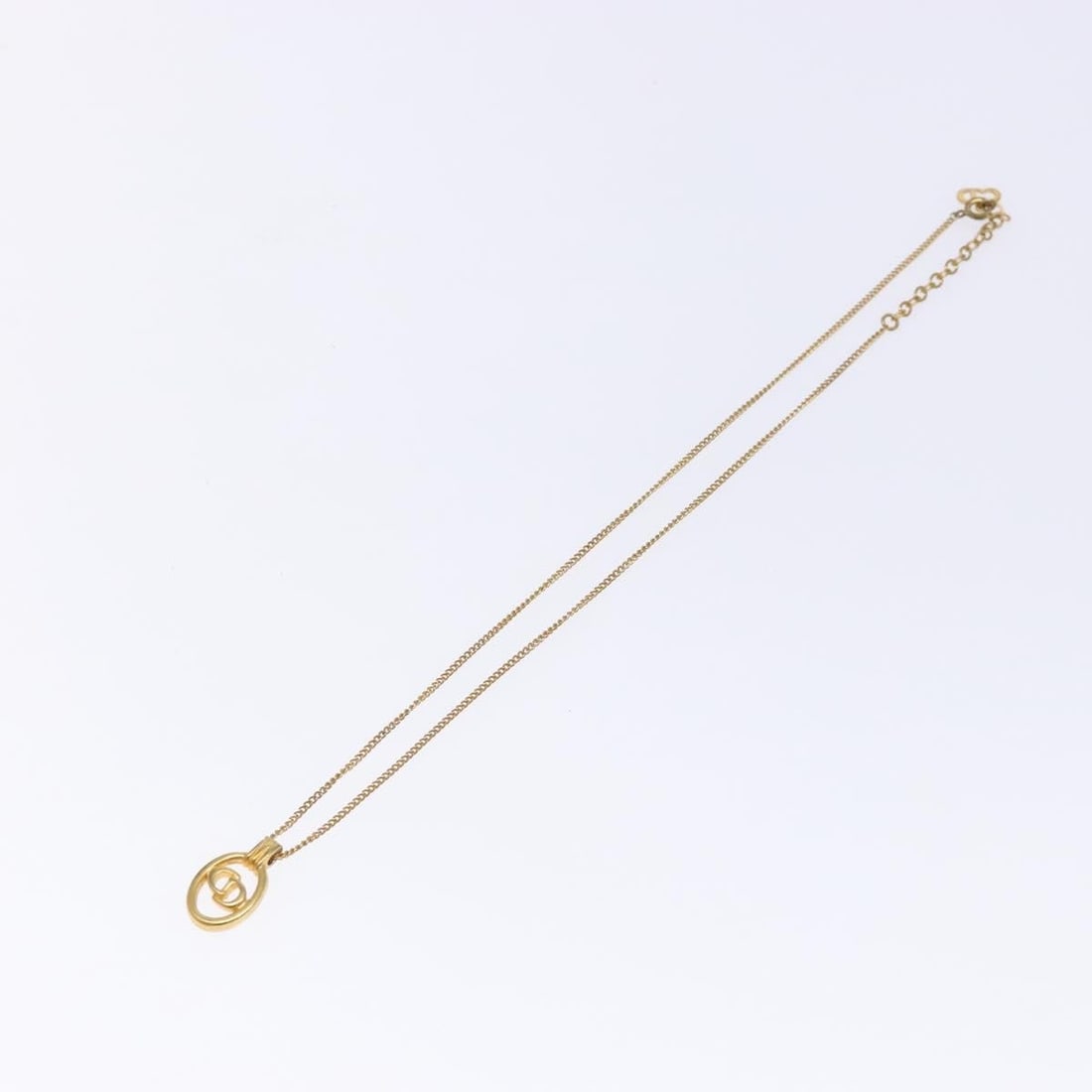 Gold Tone Christian Dior CD Logo Circular Pendant Necklace: Gold Tone Christian Dior CD Logo Circular Pendant Necklace This pre-owned Christian Dior round pendant necklace features a gold-tone finish and is designed for female wearers. The necklace shows signs