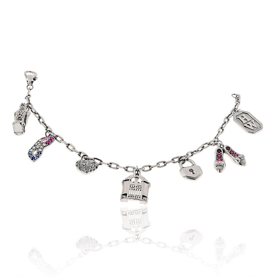 Harry Winston Vintage Platinum 7 Charm Bracelet with Diamonds and Rubies: Harry Winston Vintage Platinum 7 Charm Bracelet with Diamonds and Rubies This exquisite vintage bracelet from Harry Winston is a stunning representation of timeless elegance. Crafted in platinum, it w