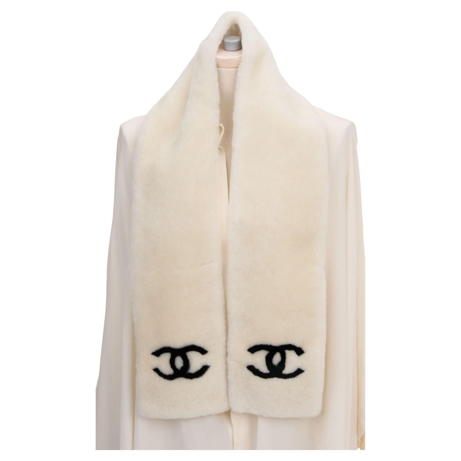 Chanel Off White Sheepskin Scarf with Black CC Logo: Chanel Off White Sheepskin Scarf with Black CC Logo Elevate your accessory collection with this Chanel Off White Shearling Logo Scarf. Crafted from luxurious sheepskin, this scarf features a chic blac