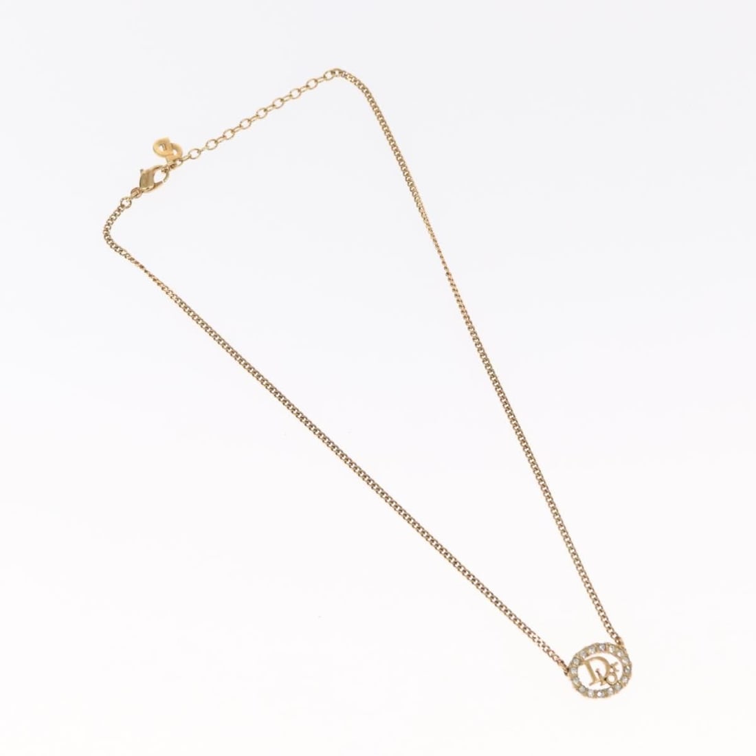 Vintage Christian Dior Circular Logo Pendant Necklace Gold Tone: Vintage Christian Dior Circular Logo Pendant Necklace Gold Tone This Christian Dior vintage necklace features a round logo pendant in a gold tone. The surface shows rubbing, and it is designed for wom