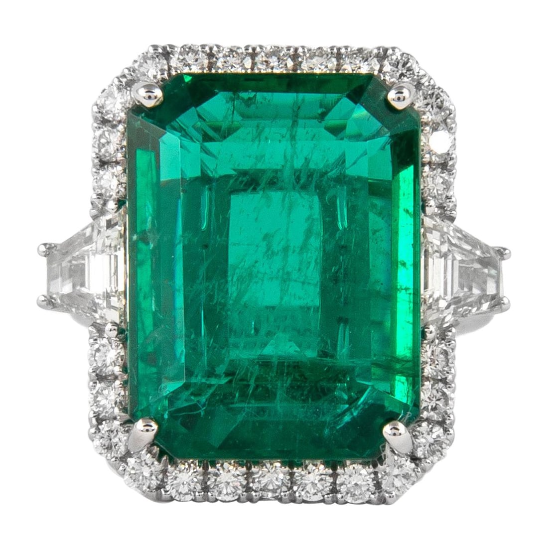 13.18ct Emerald GIA Three Stone Halo Ring in 18k White Gold: 13.18ct Emerald GIA Three Stone Halo Ring in 18k White Gold This exquisite three stone halo ring features a stunning 13.18 carat GIA certified emerald cut emerald, displaying a remarkable color that a
