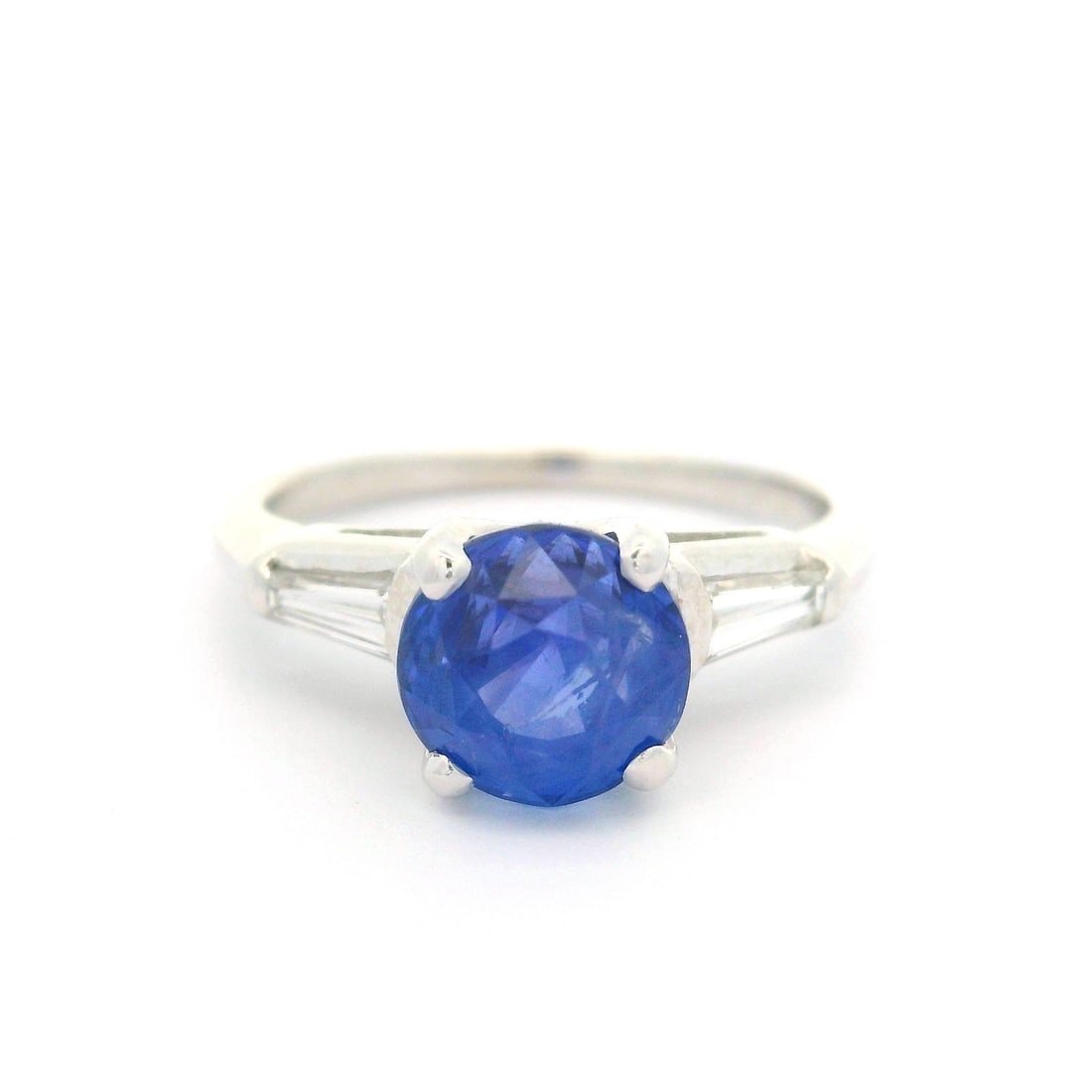 Vintage Platinum GIA Certified 2.54ct No Heat Sapphire and Baguette Diamond Ring: Vintage Platinum GIA Certified 2.54ct No Heat Sapphire and Baguette Diamond Ring This exquisite vintage ring showcases a stunning 2.54ct natural blue sapphire, known for its chunky old round cut with