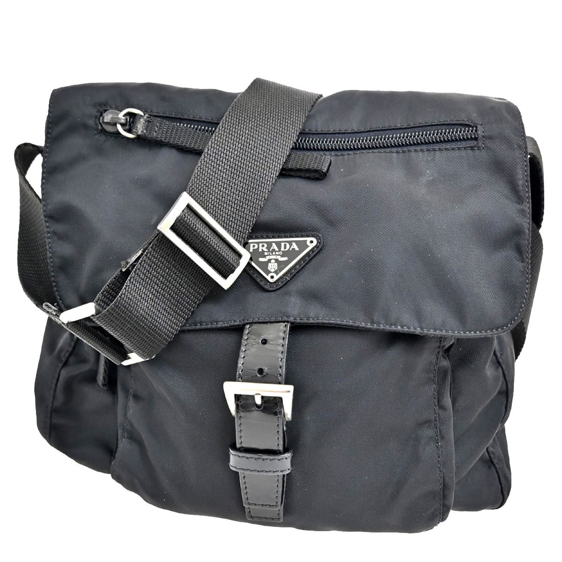 Black Prada Shoulder Bag with Buckle Detail: Black Prada Shoulder Bag with Buckle Detail This pre-owned Prada Buckle Messenger Bag is designed for women and features a classic shoulder bag style in black. The exterior displays some scuffs, dirt,