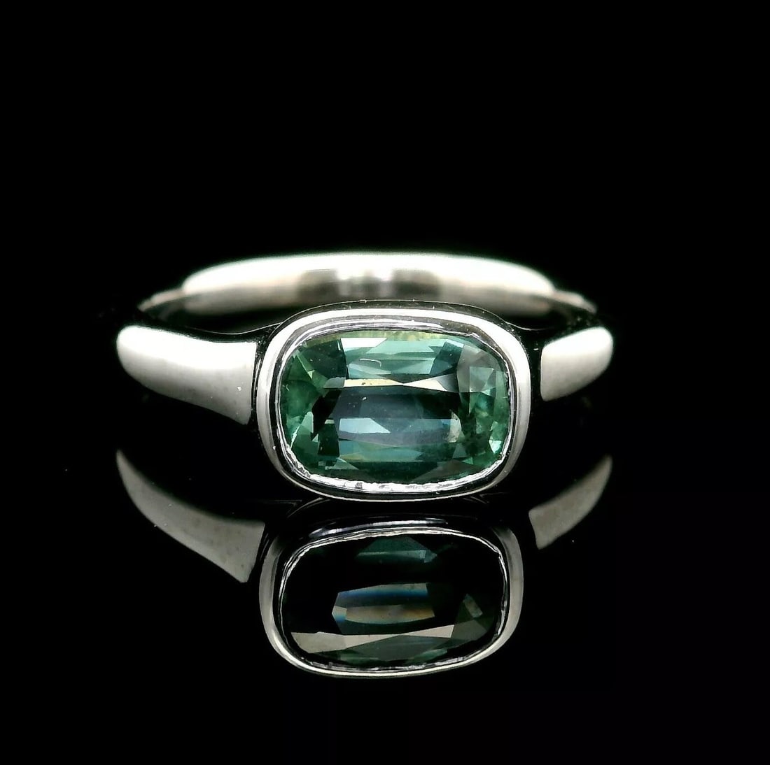 GIA Certified 1.55ct No Heat Greenish Blue Sapphire Platinum Solitaire Ring: GIA Certified 1.55ct No Heat Greenish Blue Sapphire Platinum Solitaire Ring This exquisite solitaire ring features a stunning 1.55-carat natural cushion-cut sapphire in a bezel setting. The sapphire s