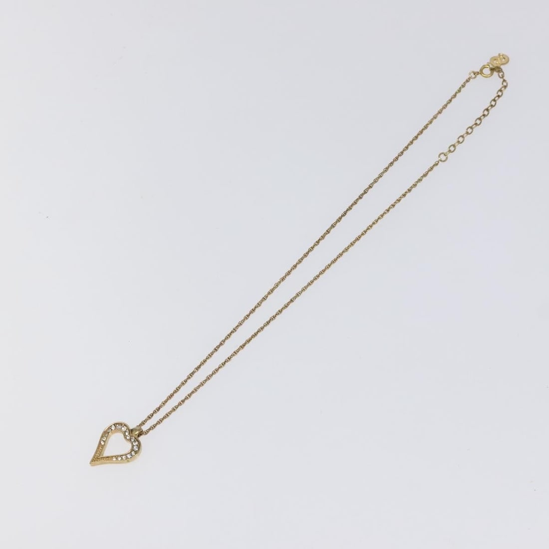 Dior Heart Shaped Pendant Necklace with Logo in Gold Tone: Dior Heart Shaped Pendant Necklace with Logo in Gold Tone This Christian Dior heart pendant necklace features a gold-tone finish with a logo design. It is intended for female wearers and is in good co