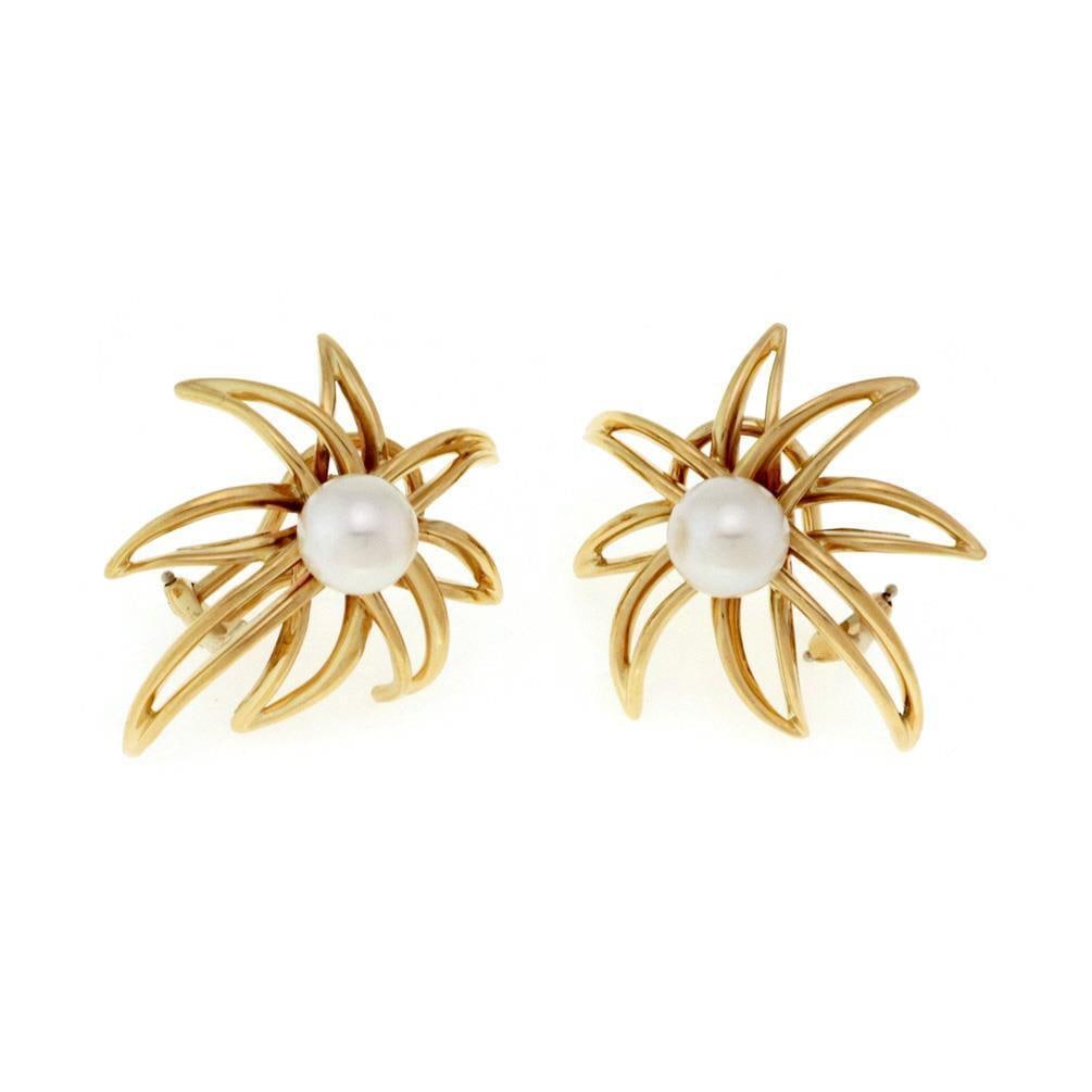 Tiffany & Co. 1994 Fireworks Collection 18k Yellow Gold Pearl Clip-On Earrings: Tiffany & Co. 1994 Fireworks Collection 18k Yellow Gold Pearl Clip-On Earrings Discover a stunning pair of vintage earrings from Tiffany & Co., crafted in 1994 as part of the FIREWORKS Collection. The