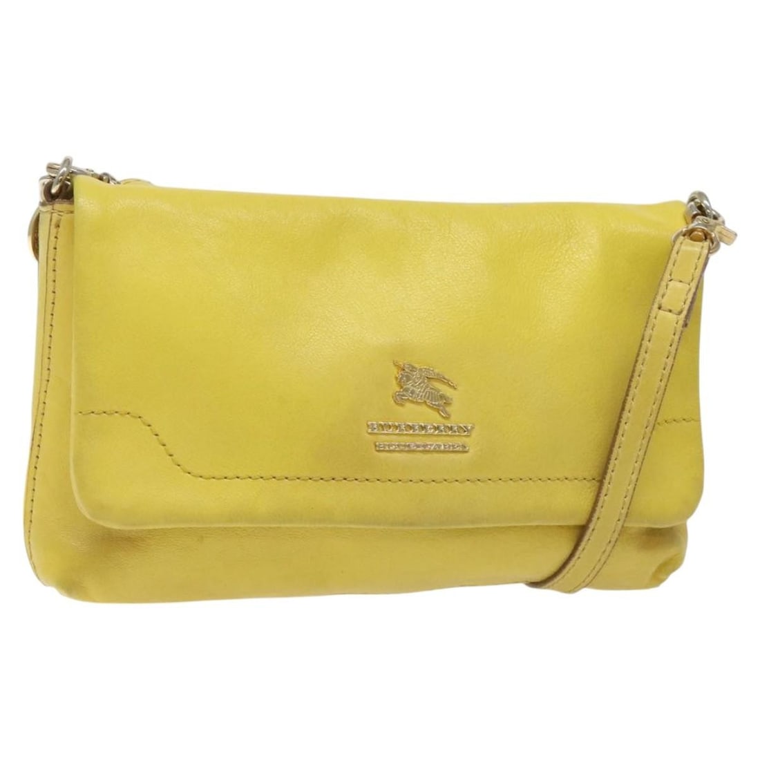 Yellow Burberry Shoulder Bag with Flap Closure: Yellow Burberry Shoulder Bag with Flap Closure This Burberry flap shoulder bag features a vibrant yellow exterior and is designed for female users. The bag shows signs of use, including loss of shape,