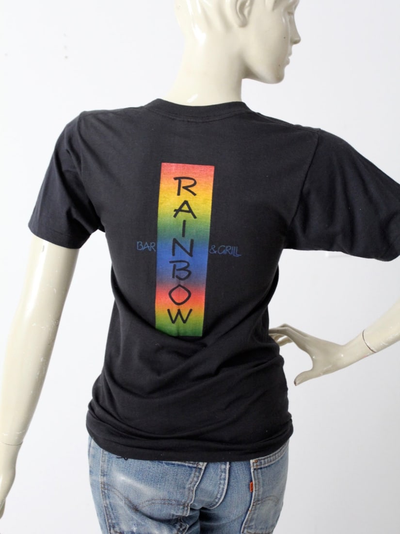 1980s Vintage Rainbow Bar & Grill Sunset Strip T-Shirt: 1980s Vintage Rainbow Bar & Grill Sunset Strip T-Shirt This 1980s vintage Rainbow Bar & Grill t-shirt is a standout piece from our Stylist Collection. The small black tee features the iconic Rainbow B