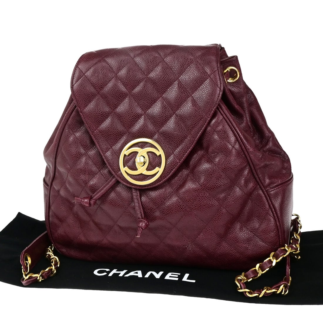 Burgundy Chanel Vintage Backpack with Gold Plated Accents: Burgundy Chanel Vintage Backpack with Gold Plated Accents This pre-owned Chanel vintage backpack in burgundy features gold-plated detailing and is designed for women. The backpack shows noticeable sig