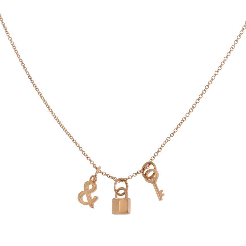 Tiffany & Co. 18k Rose Gold Lock & Key Charm Necklace: Tiffany & Co. 18k Rose Gold Lock & Key Charm Necklace This exquisite Tiffany & Co. necklace features a delightful combination of mini lock and key charms, embodying joyful moments and cherished memori