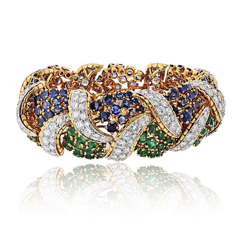18K Yellow Gold Diamond Sapphire Emerald Braided Bracelet 20 Cts: 18K Yellow Gold Diamond Sapphire Emerald Braided Bracelet 20 Cts Make a bold statement with this stunning estate bracelet crafted from 18K yellow gold. Weighing 118.6 grams and measuring 8 inches in l