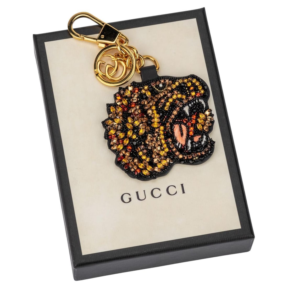 Gucci Double-Sided Tiger Beaded Logo Keychain Italy: Gucci Double-Sided Tiger Beaded Logo Keychain Italy This exquisite Gucci keychain features a unique double-sided design that enhances its charm and versatility. One side showcases a stunning beaded ti