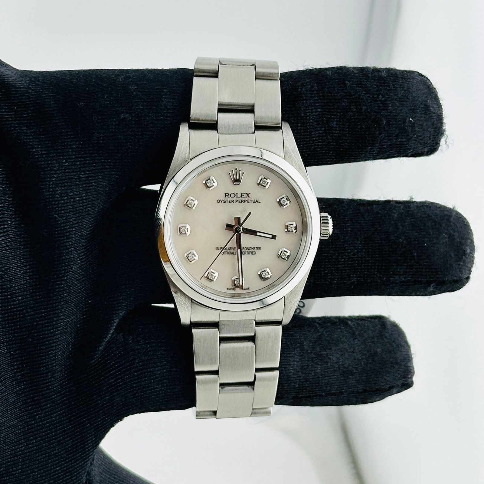 Oyster Perpetual Ref 14000 Aftermarket White MOP Diamond Dial Unisex Watch: Oyster Perpetual Ref 14000 Aftermarket White MOP Diamond Dial Unisex Watch This Rolex Oyster Perpetual features a white mother-of-pearl diamond dial set within a smooth bezel and is paired with an Oys