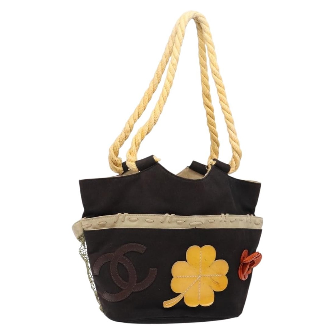 Camellia Flower Tote Bag by Chanel in Black: Camellia Flower Tote Bag by Chanel in Black This pre-owned Chanel Camellia tote bag features a classic black design adorned with the iconic camellia motif. The bag shows signs of use, including surfac