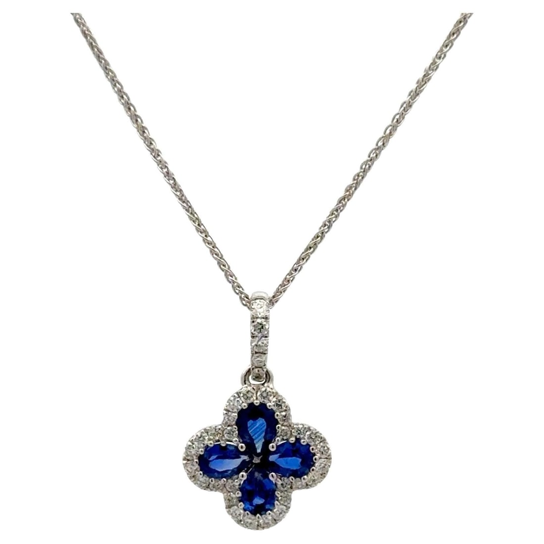 Four Leaf Clover Pendant with Pear Sapphire and Diamond Halo in 18K White Gold: Four Leaf Clover Pendant with Pear Sapphire and Diamond Halo in 18K White Gold This elegant pendant is crafted from 18K white gold and features a four-leaf clover motif composed of four pear-shaped bl