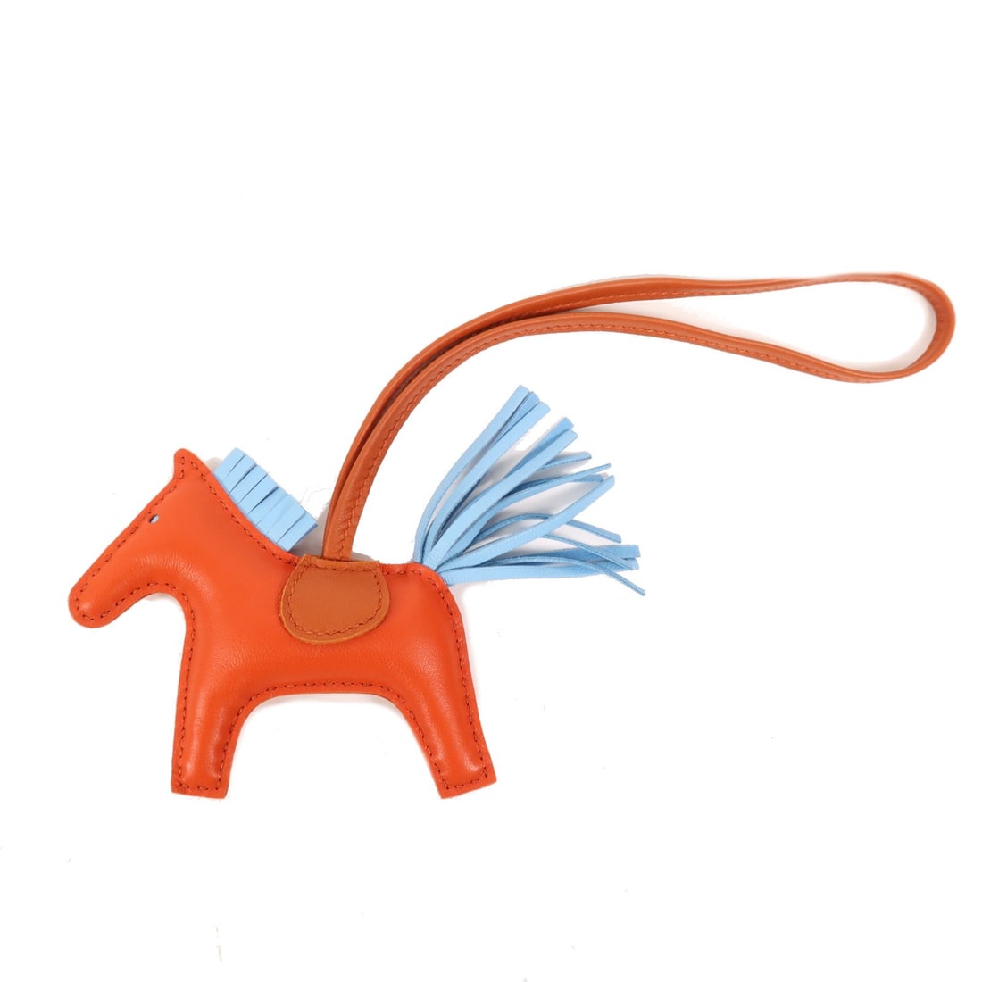 HERMES Rodeo PM Charm in Brown Orange Blue Lambskin: HERMES Rodeo PM Charm in Brown Orange Blue Lambskin Introducing the HERMES Rodeo PM Charm, an exquisite accessory crafted from high-quality lambskin (sheep leather) in a stunning combination of blue,