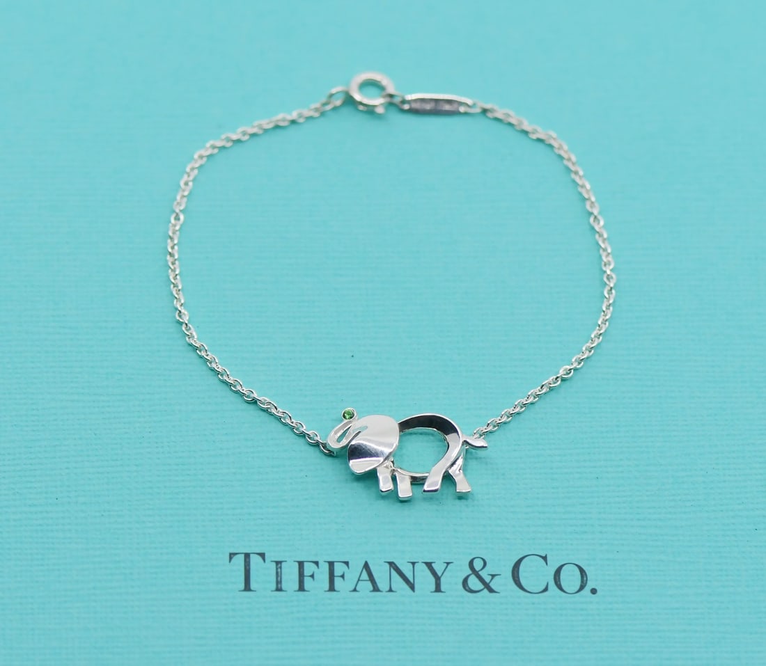Tiffany & Co Tsavorite Elephant Sterling Silver Charm Bracelet Authentic: Tiffany & Co Tsavorite Elephant Sterling Silver Charm Bracelet Authentic This exquisite Tiffany & Co. bracelet features a charming elephant design crafted in high-quality sterling silver (925). Adorne