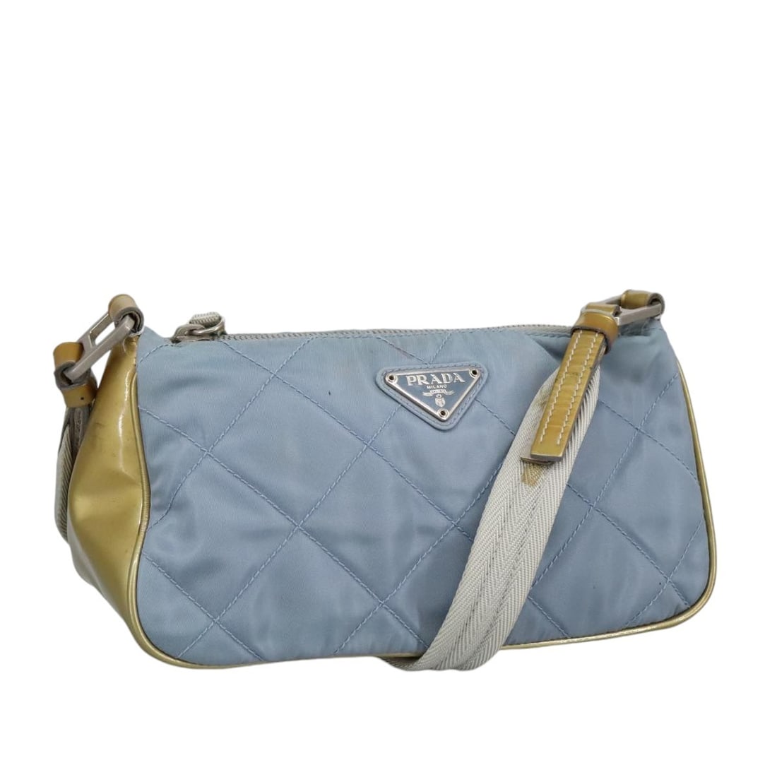 Blue Prada Vintage Shoulder Bag with Strap: Blue Prada Vintage Shoulder Bag with Strap This Prada vintage shoulder bag features a blue exterior with signs of wear, including rubbing, slight stains, and deformation on the shoulder strap. The met