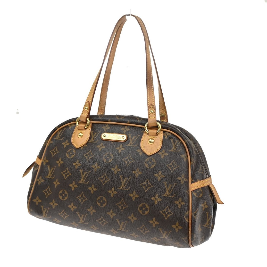 Montorgueil Shoulder Bag in Brown Canvas by Louis Vuitton: Montorgueil Shoulder Bag in Brown Canvas by Louis Vuitton This Louis Vuitton Montorgueil shoulder bag in brown is a pre-owned item with noticeable signs of use, including scuffs, dirt, and scratches o