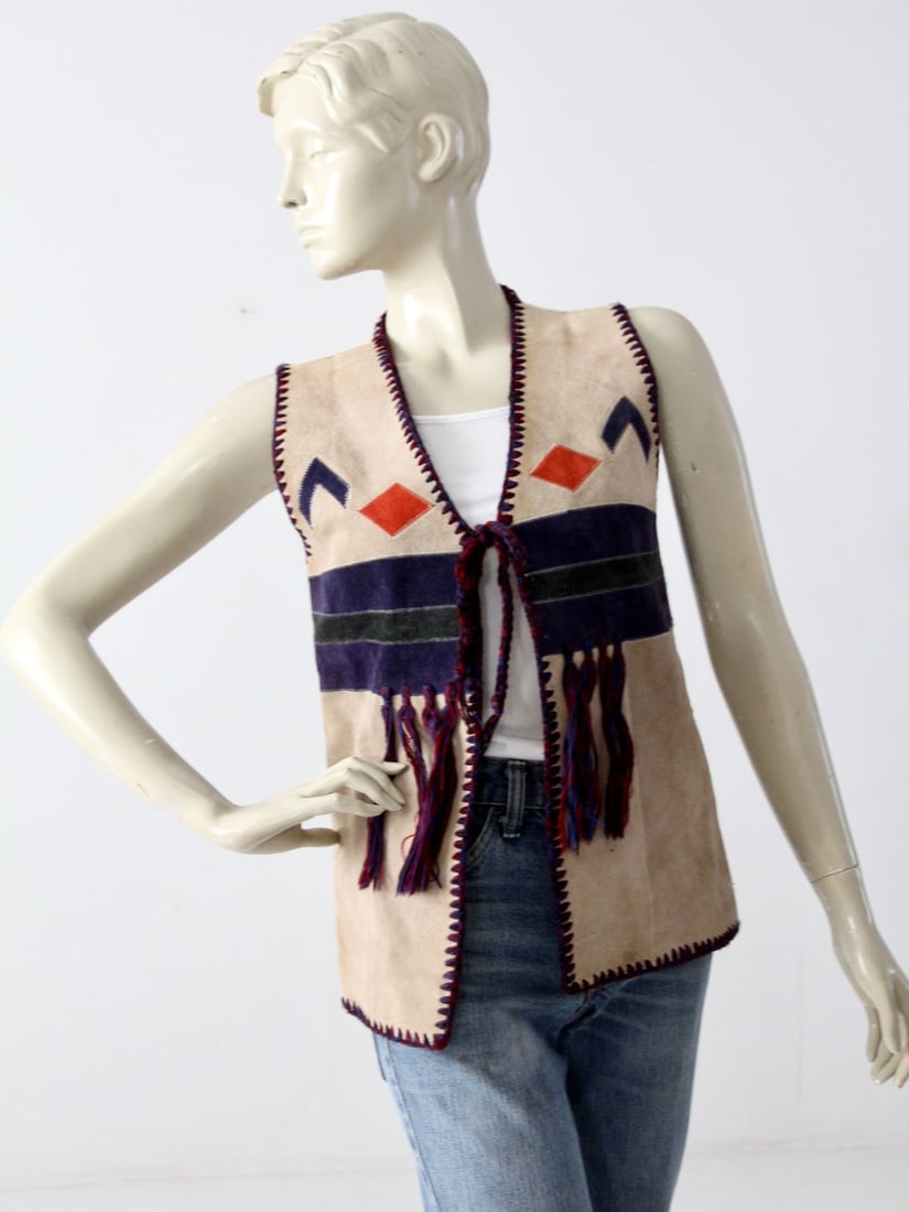 CoilAge 1970s Vintage Boho Suede Knit Vest: CoilAge 1970s Vintage Boho Suede Knit Vest This vintage 1970s southwest styled boho vest by CoilAge is a unique addition to any wardrobe. The vest features a striking front made of a patchwork of crea