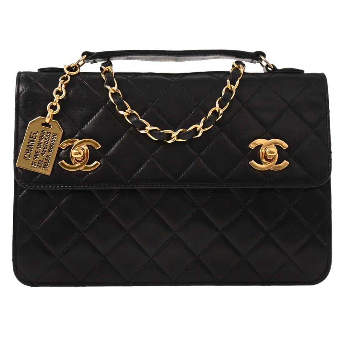Chanel Black Lambskin 2way Top Handle Handbag: Chanel Black Lambskin 2way Top Handle Handbag This stylish Chanel 2-way handbag is crafted from luxurious black lambskin, embodying both elegance and practicality. Designed for casual occasions, it fe