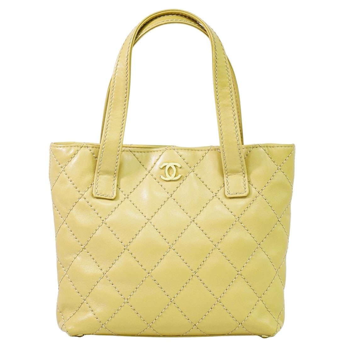 Wild Stitch Beige Tote Bag by Chanel: Wild Stitch Beige Tote Bag by Chanel This pre-owned Chanel Wild Stitch tote bag features a beige exterior and is designed for women. The bag shows signs of use, including some wear, stains, a slight s