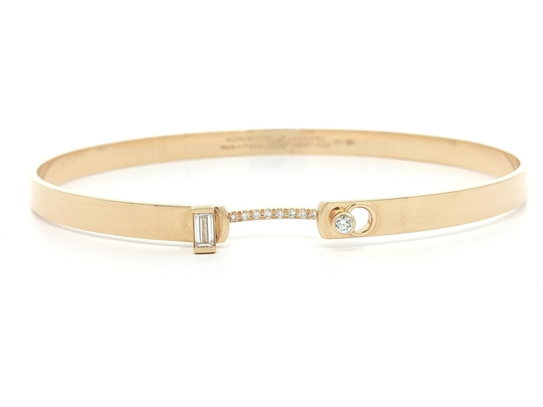 Diamond Bangle Bracelet in 18k Yellow Gold by Nouvel Heritage France: Diamond Bangle Bracelet in 18k Yellow Gold by Nouvel Heritage France This French Heritage bangle bracelet is crafted from solid 18k yellow gold and features numerous natural white diamonds with a tota