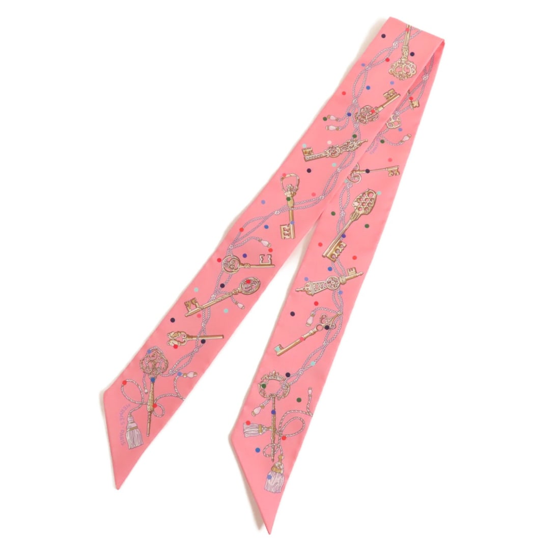 HERMES Pink Silk Twilly Scarf Made in France: HERMES Pink Silk Twilly Scarf Made in France Experience the elegance of HERMES with this exquisite Twilly scarf. Made from luxurious silk, this scarf features a beautiful pink hue that adds a touch of