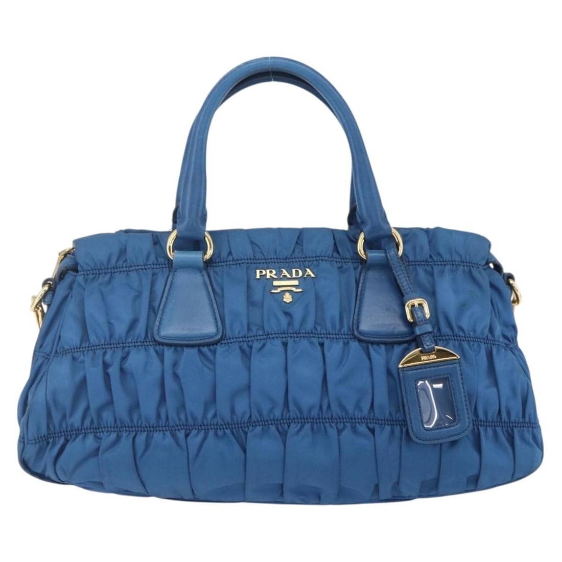 Blue Gaufre Convertible Satchel by Prada with Gathered Leather Design: Blue Gaufre Convertible Satchel by Prada with Gathered Leather Design This pre-owned Prada Gaufre Convertible Satchel in blue features gathered leather construction with a convertible design. The hand