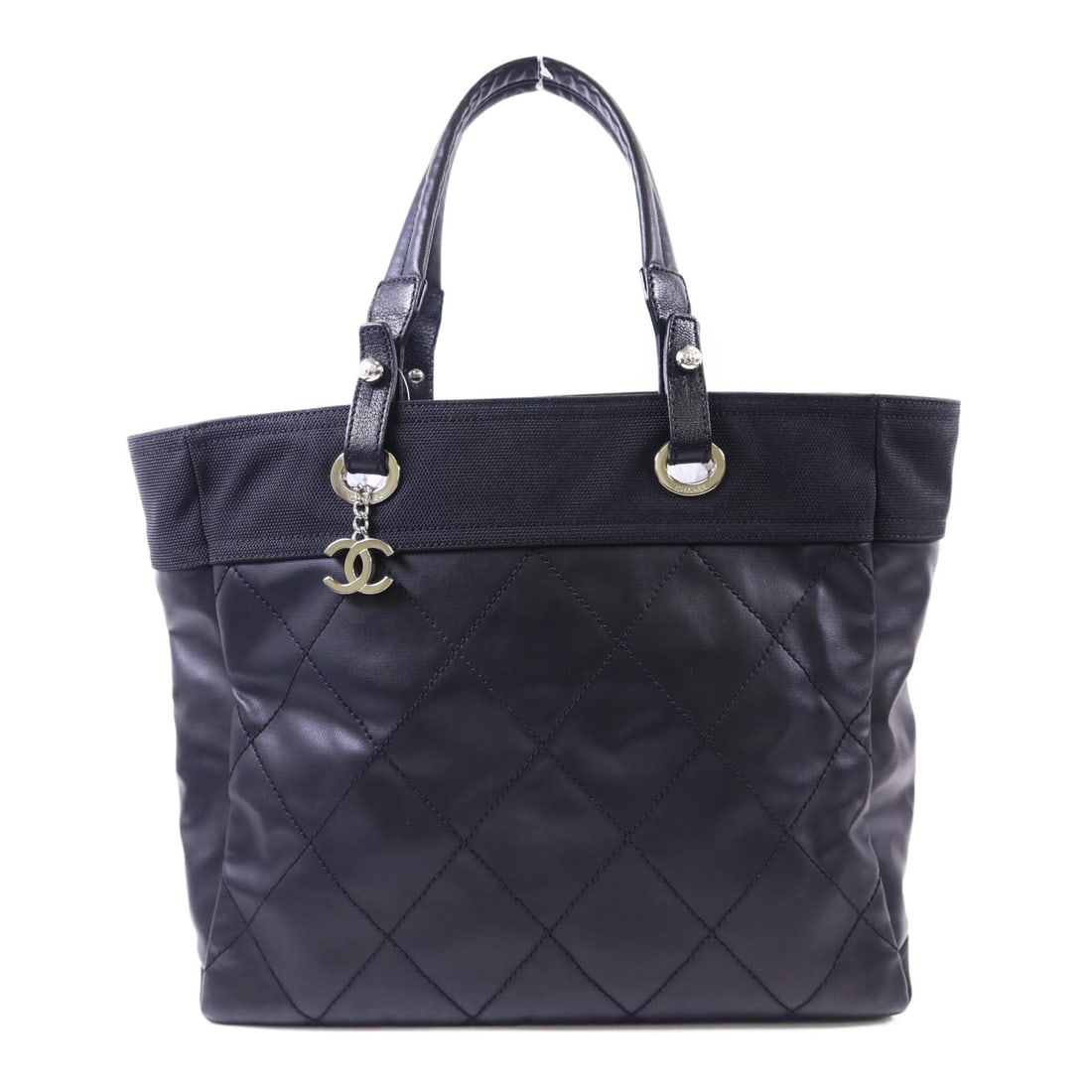 Black Biarritz Tote by CHANEL in Nylon with Silver Tone Hardware: Black Biarritz Tote by CHANEL in Nylon with Silver Tone Hardware This CHANEL Biarritz tote bag features a black nylon coated canvas exterior and a classic tote design. The bag is crafted in France and