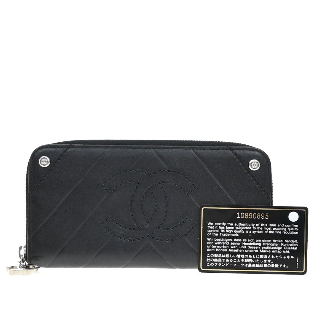 Black Zip Wallet with CC Charm by Chanel: Black Zip Wallet with CC Charm by Chanel This pre-owned Chanel CC Charm Zip Around Wallet features a black exterior and is designed for female users. The wallet displays signs of wear, including scuff