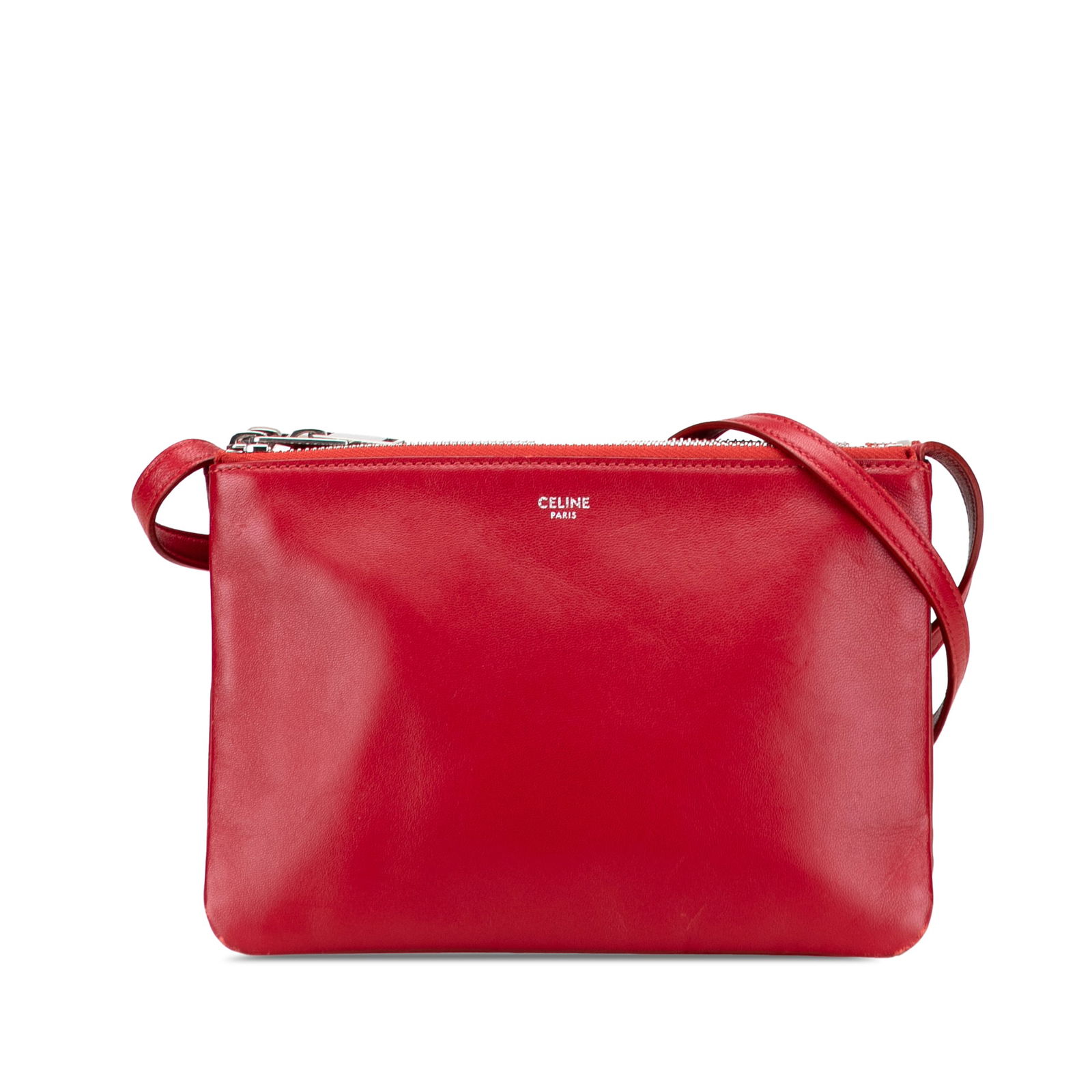 Celine Small Red Lambskin Trio Crossbody Bag with Adjustable Strap: Celine Small Red Lambskin Trio Crossbody Bag with Adjustable Strap The Celine Small Lambskin Trio Crossbody bag is a stylish accessory crafted from premium leather. This bag features an adjustable fla
