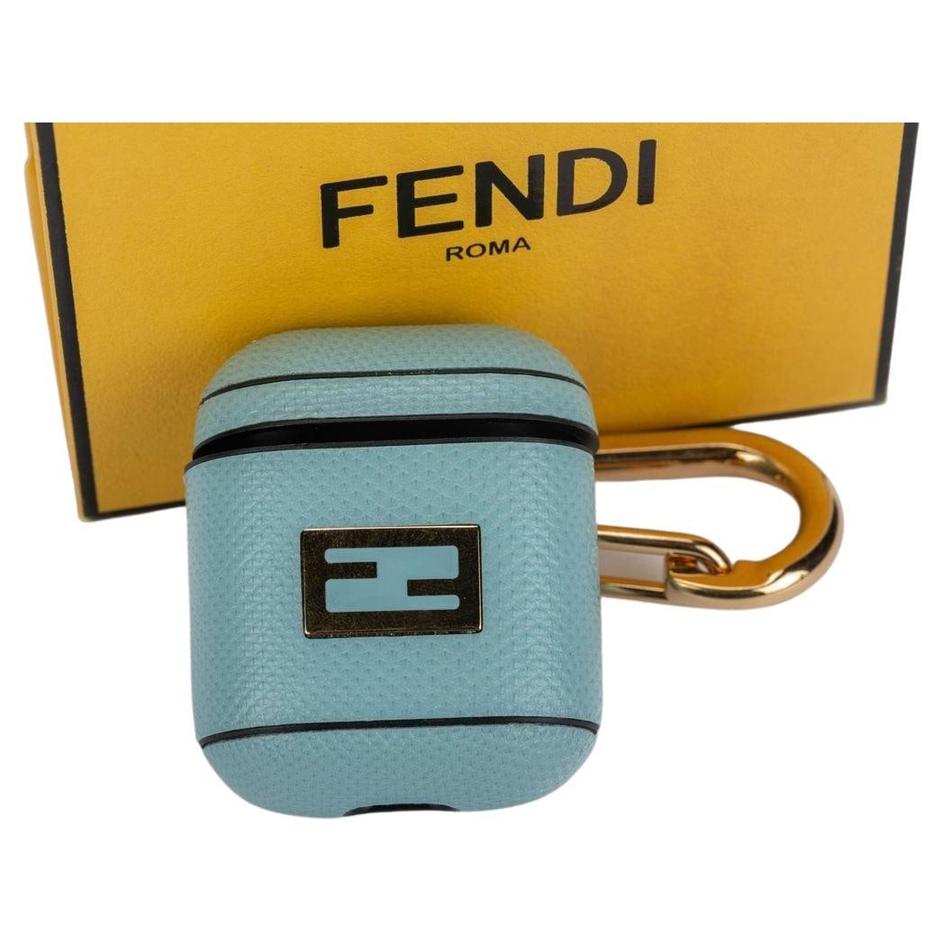 Fendi Light Blue Leather AirPod Case with Gold Clasp NIB: Fendi Light Blue Leather AirPod Case with Gold Clasp NIB This exquisite Fendi AirPod case is crafted from premium leather in a delightful light blue hue. Designed as a stylish charm, it features a gol