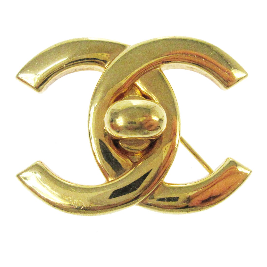 Chanel Large Turnlock Brooch Pin Gold-tone Logo 96P: Chanel Large Turnlock Brooch Pin Gold-tone Logo 96P This exquisite Chanel Turnlock Brooch Pin is a striking accessory that features a classic logo design. Crafted in a stunning gold-tone finish, this